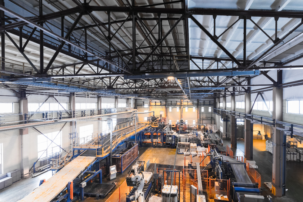 High view of a manufacturing facility with machines ad equipment to represent SharePoint for manufacturer