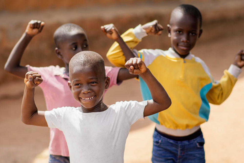 African children smiling and playing together representing Compassion UK children's charity.